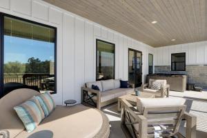 a screened in porch with a couch and chairs at Here Comes the Sun in Canyon Lake