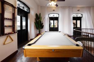 a pool table in the middle of a room at AmazINN Places Casco Viejo relaxing Views and Sound of the Sea in Panama City