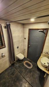 a small bathroom with a toilet and a sink at MAP RESORT in Alibaug
