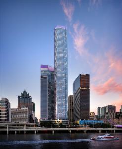 a city skyline with a tall building and a river at CBD Luxury River View 1Bed Apt The One in Brisbane