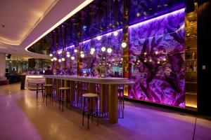 a bar in a restaurant with purple lighting at CBD Luxury River View 1Bed Apt The One in Brisbane