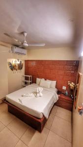 a bedroom with a bed with a cat laying on it at MAP RESORT in Alibaug