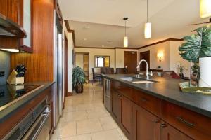 a large kitchen with a sink and a counter at Ko Olina Beach Villas O410 - 2BR Luxury Condo with Partial Ocean View in Kapolei