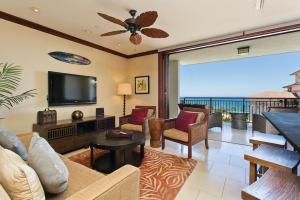 a living room with a couch and a tv at Ko Olina Beach Villas O1002 - 3BR Luxury Condo with Stunning Ocean View & 2 Free Parking in Kapolei