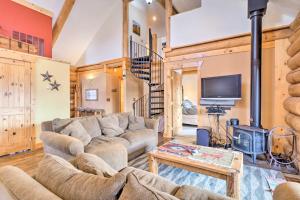 a living room with a couch and a tv at Granby Home with Mountain Views and Fire Pit in Granby