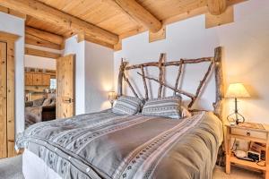 a bedroom with a large bed with a wooden headboard at Granby Home with Mountain Views and Fire Pit in Granby