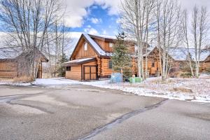 a log house with a driveway in front of it at Granby Home with Mountain Views and Fire Pit in Granby