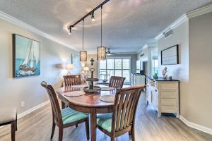 a dining room and kitchen with a table and chairs at Sunlit St Petersburg Condo with Community Pool in St Petersburg
