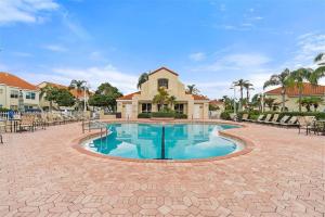 a swimming pool in the middle of a courtyard at Sunlit St Petersburg Condo with Community Pool in St Petersburg