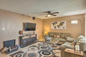 a living room with a couch and a flat screen tv at Well-Appointed Glendale Home with Outdoor Pool! in Glendale