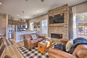 a living room with a couch and a fireplace at Woodland Park Escape Licensed, Hot Tub, Mtn Views in Woodland Park