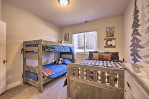 a bedroom with two bunk beds and a window at Woodland Park Escape Licensed, Hot Tub, Mtn Views in Woodland Park