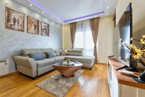 a living room with a couch and a table at Stek Hills Zlatibor in Zlatibor