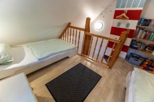 a small bedroom with a bed and a staircase at Dat Südstrandhuus- Ferienwohnung Silke in Wyk auf Föhr