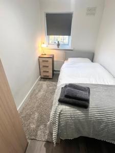 a small bedroom with a bed and a window at Lovely Single Room in Hither Green