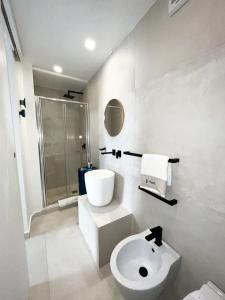 a bathroom with a toilet and a sink and a shower at Artemide Luxury Home in Syracuse