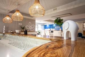 a bar with wine glasses on a counter at Sentido Michelizia Tropea Resort in Tropea