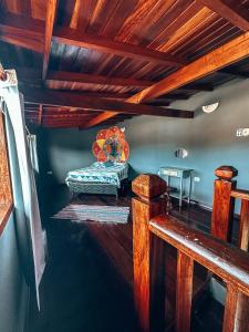 - une chambre avec un banc dans une chambre dotée de plafonds en bois dans l'établissement Hostel 420, à Parati