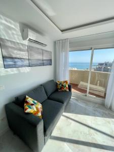 ein Wohnzimmer mit einem Sofa und Meerblick in der Unterkunft Benal Beach Sun in Benalmádena