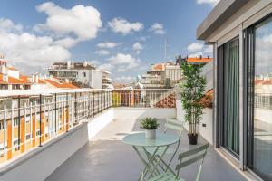 a balcony with a table and chairs and a view at Succeed Campo Pequeno Apartments in Lisbon