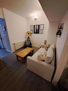 a living room with a couch and a table at Church view in Wick