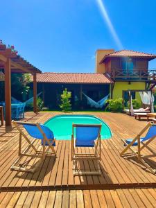 a deck with two chairs and a swimming pool at TROPICAL HOUSE ATINS in Atins