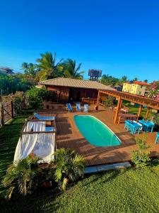 a swimming pool on a deck next to a house at TROPICAL HOUSE ATINS in Atins