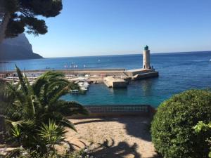 un faro in acqua vicino a una spiaggia di L’Aiguade, appartement d'exception à Cassis a Cassis