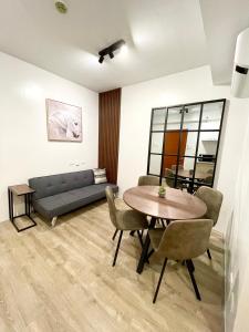 a living room with a table and a couch at One bedroom Condo Suite in Bacolod City in Bacolod