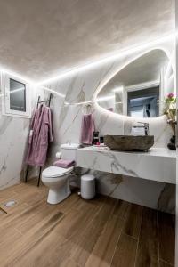 a bathroom with a sink and a toilet in it at Escape Luxury Apartment in Nafplio +87 photos
