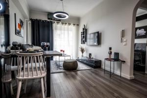 a living room with a table and chairs in it at Escape Luxury Apartment in Nafplio