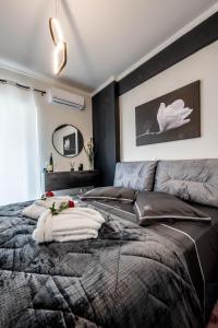 a bedroom with a large bed with a black wall at Escape Luxury Apartment in Nafplio