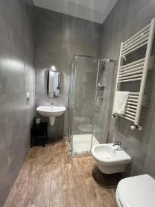 a bathroom with a shower and a sink and a toilet at Il Civico 2 in Bari