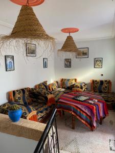 a living room with a couch and a table at Emallayan Hostel in Imsouane