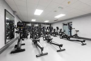 a gym with a bunch of treadmills and machines at Gloucester Robinswood Hotel, BW Signature Collection in Gloucester