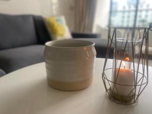 a candle and a candle holder on a table at Luxueux appartement avec vue panoramique in Mohammedia