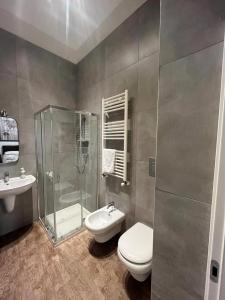 a bathroom with a shower and a toilet and a sink at Il Civico 2 in Bari