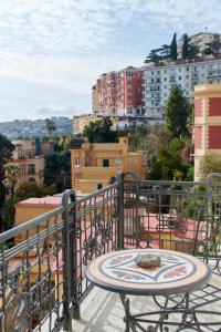 a table on a balcony with a view of a city at Villa Margherita in Naples