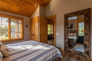 a bedroom with a bed and a mirror at Valley View in Banner Elk