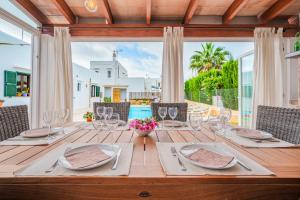 a wooden table with plates and glasses on it at Casa Carmela in Cacla D'or +37 photos