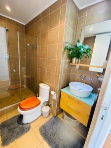 a bathroom with a toilet and a sink at The Waves, 806 Quayside Point Waterfront in Durban