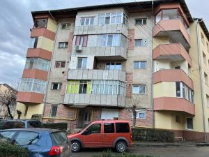 a red van parked in front of a building at Comfy Condo Zalau in Zalău