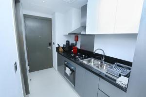 a kitchen with a sink and a counter top at DAMAC MAISON PRIVE in Dubai