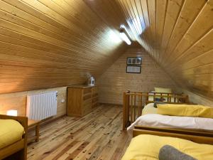 a attic room with two beds and a wooden ceiling at Sierra Nevada Cabaña de madera in Sierra Nevada
