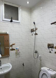 a bathroom with a shower and a toilet and a sink at GHEST HOUSE BASS in Dakar