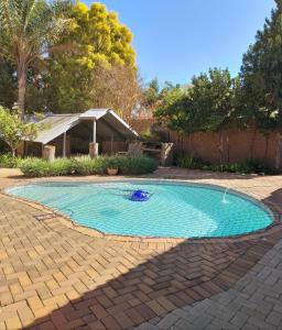 a swimming pool in the middle of a yard at ZUCH Accommodation at Pafuri Self Catering - Guest Cabin in Polokwane