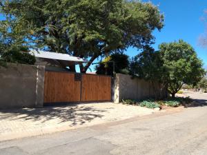 a wooden fence in front of a house at ZUCH Accommodation at Pafuri Self Catering - Guest Cabin in Polokwane