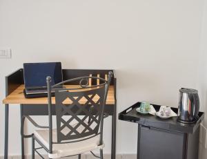 a desk with a chair and a laptop computer on it at Villa Margherita in Naples
