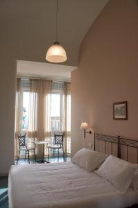 a bedroom with a bed and a table and chairs at Villa Margherita in Naples