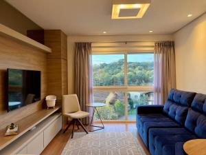 TV a/nebo společenská místnost v ubytování Apartamentos VENTURA a 5 min do CENTRO by Achei Gramado